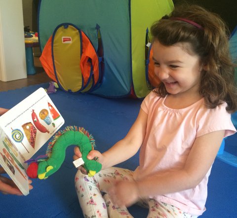 Child using a story to engage in language skills
